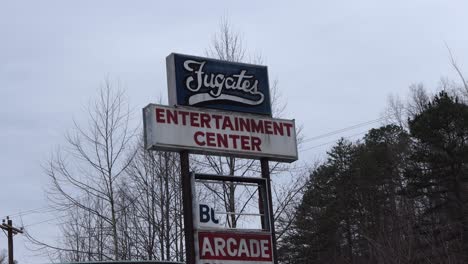 Static-Shot-of-the-Abandoned-Fugates-Entertainment-Center-Sign-in-Eastern-Kentucky-with-Trees-in-the-Background