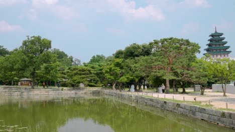 Tourists-sightseeing-walking-by-Hyangwonji-Pond-in-Gyeongbokgung-Palace-in-Seoul