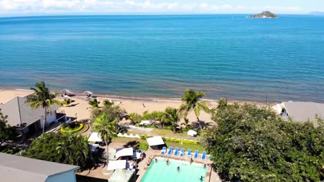 Lake-Malawi-Aerial-Drone-View,-People-Enjoy-Pool-at-Beach-Resort