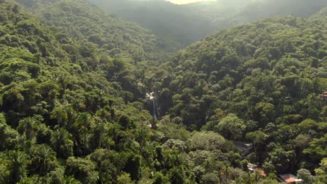 Flight-Over-Dense-Thicket-With-Yelapa-Waterfall-In-Jalisco,-Mexico