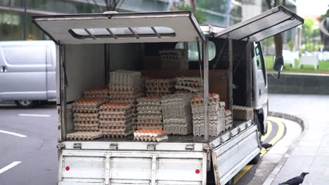 Truck-with-doors-open-full-of-egg-trays