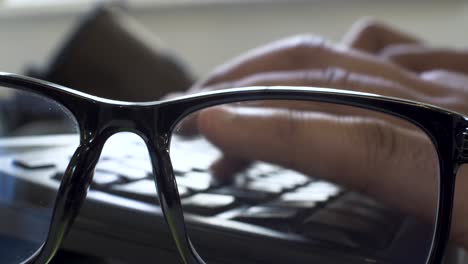 Glasses-with-Blue-Filter-and-Typing-on-Keyboard-in-Closeup