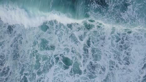 overhead-drone-shot-of-sea-waves-with-white-foam
