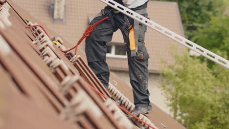 Worker-installing-railings-for-solar-panels-on-roof