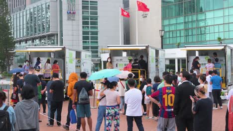 People-queue-in-line-to-receive-PCR-tests-for-coronavirus-from-Community-Testing-Centre-trucks-to-tackle-the-spread-of-the-virus-and-a-pandemic-wave-near-Hong-Kong's-financial-district