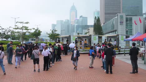 People-queue-in-line-to-receive-PCR-tests-for-coronavirus-from-Community-Testing-Centre-trucks-to-tackle-the-spread-of-the-virus-and-a-pandemic-wave-near-Hong-Kong's-financial-district