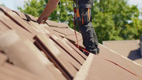 Static-shot-of-roof-tile-removal-for-solar-panel-installation-at-sunny-day