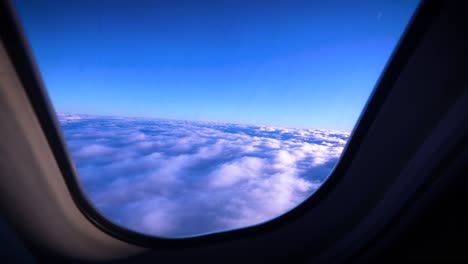 Beautiful-view-out-of-airplane-window-of-the-tops-of-clouds