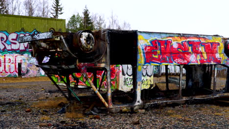 Burnt-down-buss-covered-in-graffiti-and-stripped-of-tires