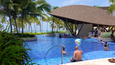 People-enjoy-resort-pool-on-summer-vacation