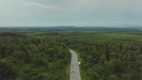 Flying-Over-Remote-Road-Amidst-Sweeping-Forestland-Near-Anchorage,-Alaska