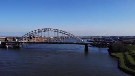 Arch-Bridge-Over-Noord-River-With-A-View-Of-Hendrik-Ido-Ambacht-Town-In-South-Holland,-Netherlands