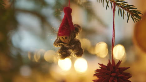 CHRISTMAS-DECORATIONS---Cute-and-tiny-elf-on-a-Christmas-tree,-Sweden,-close-up