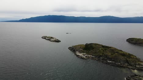 Aerial-shot-of-Hodgson-Island-in-vast-water-landscape-in-British-Columbia