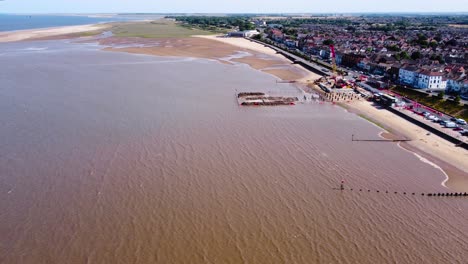 Aerial-rising-orbit-above-Grimsby-Cleethorpes-suburban-holiday-town-property-close-to-sandy-beach-waterfront