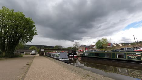 Tourists-at-Trevor-basin-British-aqueduct-canal-bridge-boats-time-lapse-under-passing-stormy-weather-clouds