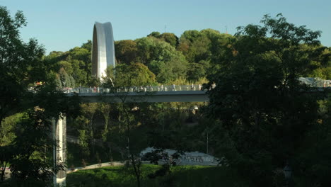 Wide-clip-of-the-glass-bridge-and-friendship-arch-in-Kiev-on-a-warm-autumn-evening