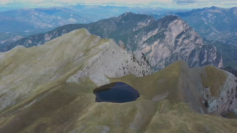 Aerial-view-of-top-of-Tymfi-and-Smolikas-mountain,-Drakolimni-lake