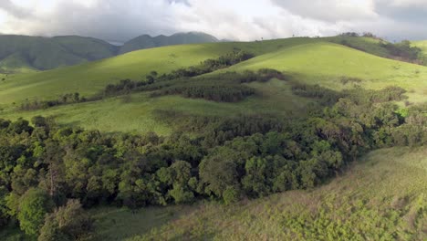 4k-aerial-drone-footage-flying-over-lush-green-forest-hills-on-a-beautiful-day