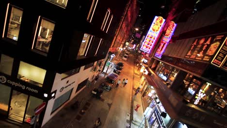 Vertigo-View,-Pedestrian-Street-at-NIght-in-Central-Hong-Kong,-China,-People-and-Stores-During-Covid-19-Virus-Pandemic