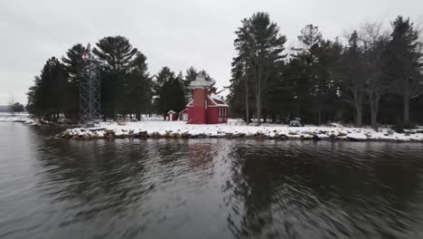4k-drone-video-of-Sandpoint-Lighthouse-in-Baraga,-Michigan-in-the-winter