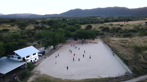 Drone-shot-of-a-group-of-kids-playing-soccer