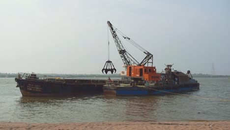 A-Huge-Shipping-crane-mining-or-digging-Bay,-ocean-near-a-Mumbai,-Engineers-and-workers-working-on-Big-ship-crane,-digging-or-Mining-ocean-with-big-Machinery,-Technological,-Industrial-concept