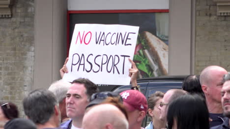 A-protestor-holds-up-a-placard-that-says-“No-vaccine-passport”-on-a-Coronavirus-conspiracy-protest