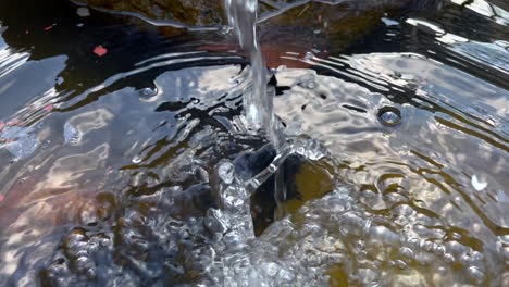 Slow-motion-shot-of-splashing-water-of-fishpond-pump-for-fresh-oxygenated-water-for-fishes-life