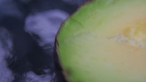 Highly-detailed-close-up-of-a-spinning-avocado,-that's-cut-in-half-with-the-seed-removed