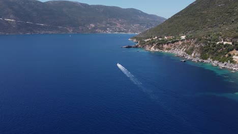 Speedboat-cruising-along-next-to-beautiful-Lefkada-coastline,-close-to-Vasiliki-Village
