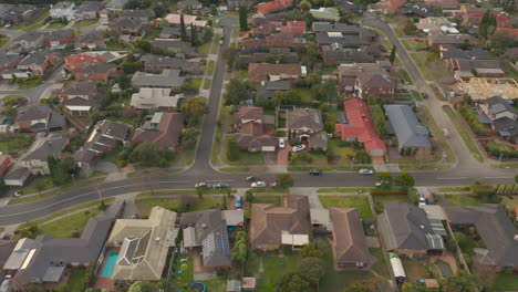 Aerial-view-tracking-black-SUV-driving-toward-suburban-destination