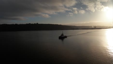 Orbiting-a-Crowley-tugboat-as-it-leaves-the-Port-of-Tacoma,-golden-sunrise,-aerial,-illustrative-editorial