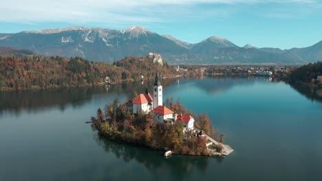 Calm-reflection-water-on-Lake-Bled-as-the-Drone-shows-an-aerial-view-of-Lake-Bled-Island-and-church-and-Mountain-Stol-in-the-background