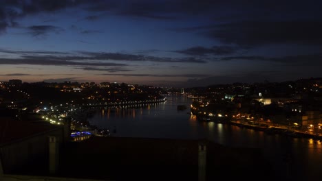 Static-shot-of-a-late-evening-overlooking-the-city-lights-of-Porto-Portugal-and-the-Douro-river