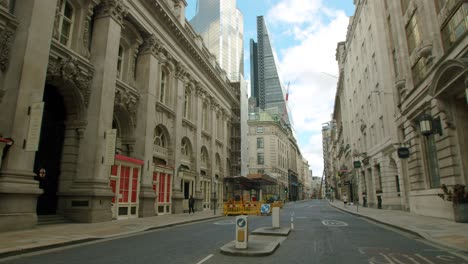 Slow-motion-reveal-of-The-City-of-London-skyscrapers-with-empty-streets,-during-the-Coronavirus-lockdown-pandemic-2020