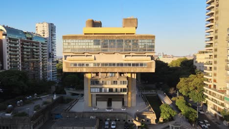 Aerial-pan-left-of-Buenos-Aires-National-Library-between-trees-and-Recoleta-buildings-at-golden-hour