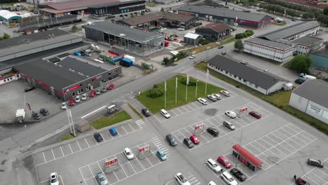 Dolly-out-aerial-view-of-an-empty-parking-lot-of-famous-Swedish-local-supermarket-Willys-shopping-center-at-Trollhattan-Sweden-during-global-pandemic-period