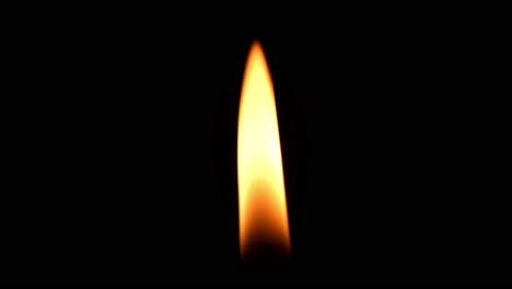 One-candle-burning-brightly-against-black-background