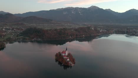 Gorgeous-morning-sunrise-of-Lake-Bled-Island-with-bright-red-skies-with-a-aerial-view-of-Lake-Bled