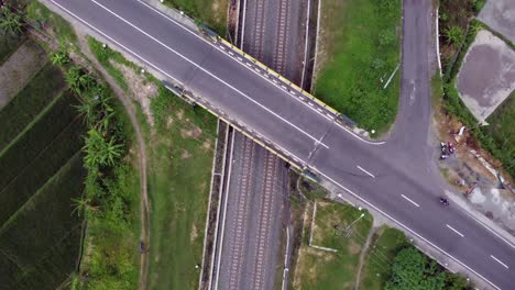 Aerial-view-of-the-railway-line-in-the-rice-fields-and-under-the-highway
