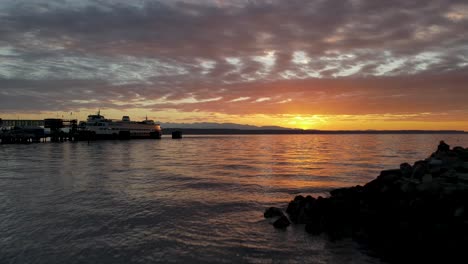 Aerial-shot-of-breathtaking-sunset-behind-the-Edmonds-ferry-in-Washington-state