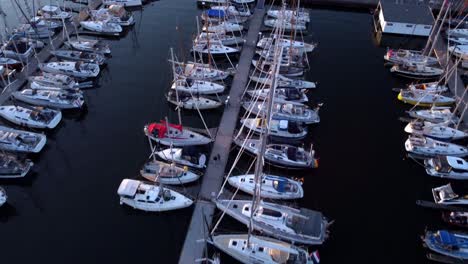 sailing-boats,-top-view-in-Marina,-docked-at-the-pier-during-the-sunset-01