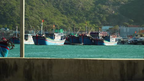 Fishing-boat-sailing-on-turquoise-water-in-port,-Vinh-Hy-Bay,-Vietnam