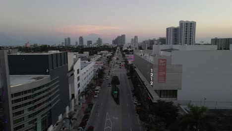 POV-aerial-over-Alton-Rd,-Miami-passes-people-on-parkade-top-level