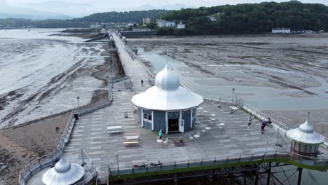 Bangor-seaside-pier-North-Wales-silver-spire-pavilion-low-tide-aerial-view-reverse-tracking-right