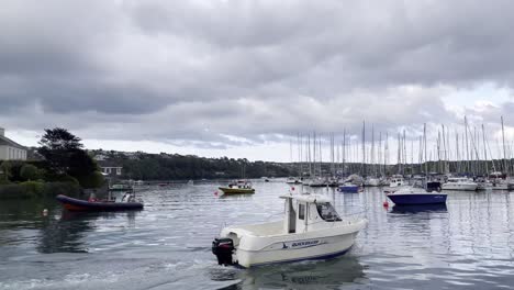 Calm-and-cloudy-evening-during-high-tide-in-Kinsale-Harbour-with-yachts-and-boat-passing