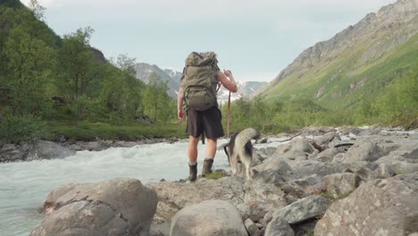 Fast-Flowing-Stream-With-Hiker-And-Dog-On-Leash-In-Lyngsdalen-Mountain-Hike-In-Norway