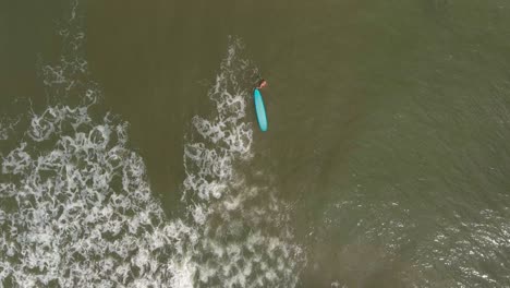 Birds-eye-view-of-female-surfer-in-the-Gulf-of-Mexico-off-the-coast-of-Lake-Jackson-in-Texas