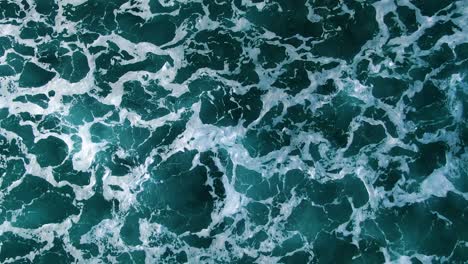 Close-up-birds-eye-view-footage-of-deep-blue-ocean-white-wash-in-hawaii